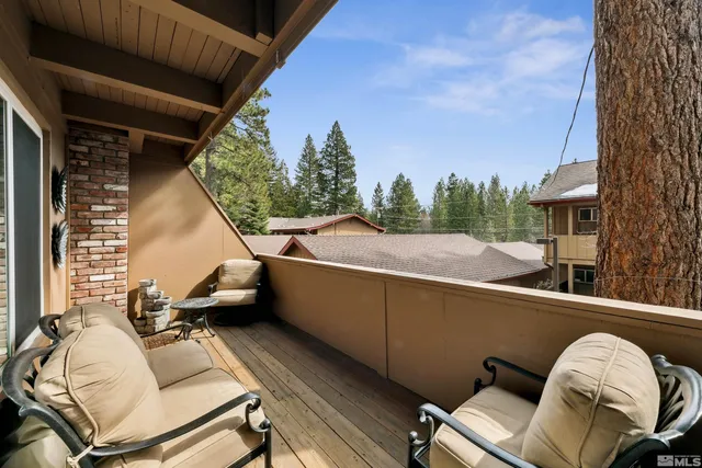 a view of a balcony with chair and a barbeque