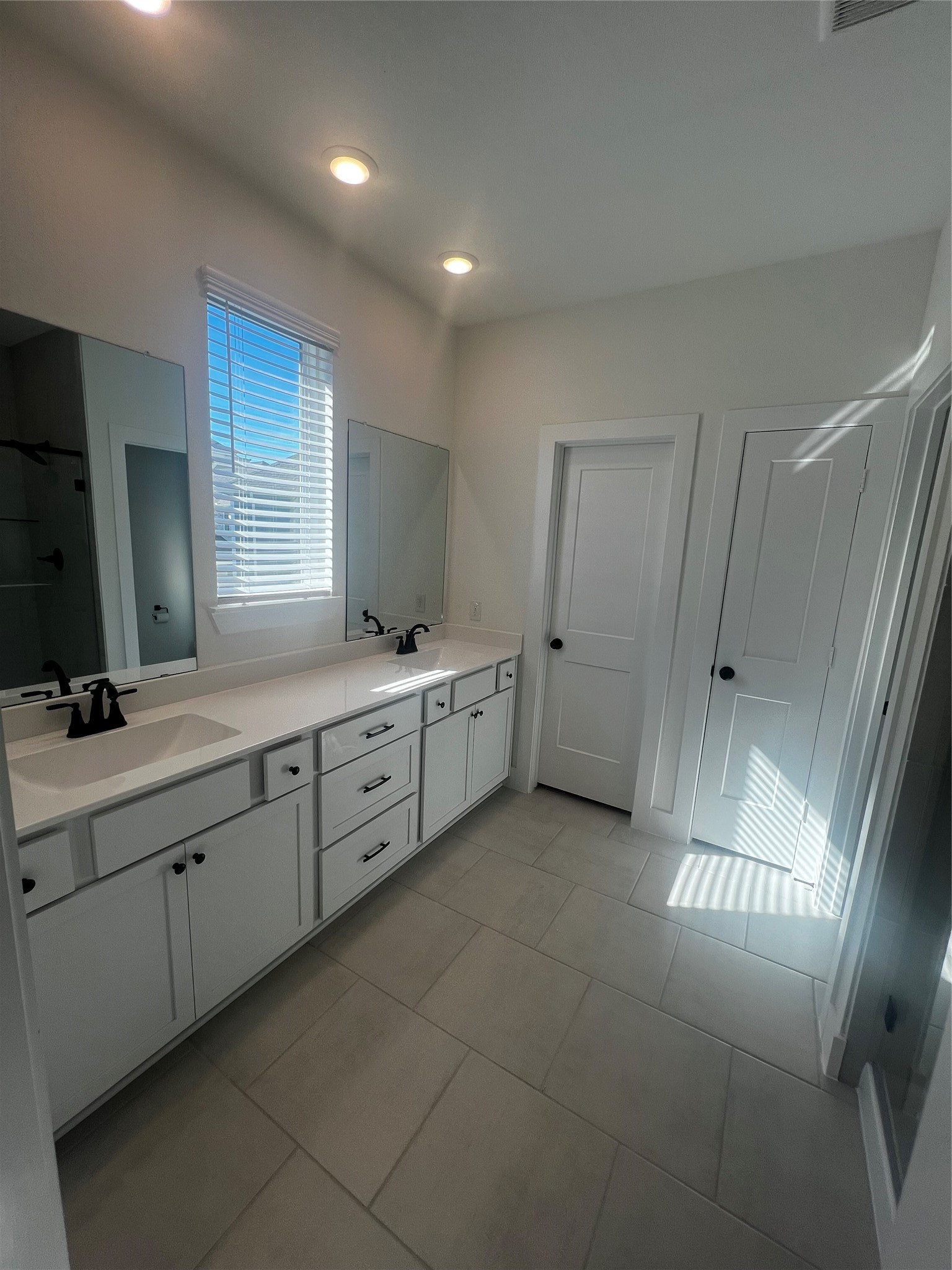 7743 Swooping Swallow Lane Katy, TX 77493 - Photo 22 of 45 a large bathroom with a double vanity sink a large mirror and a shower