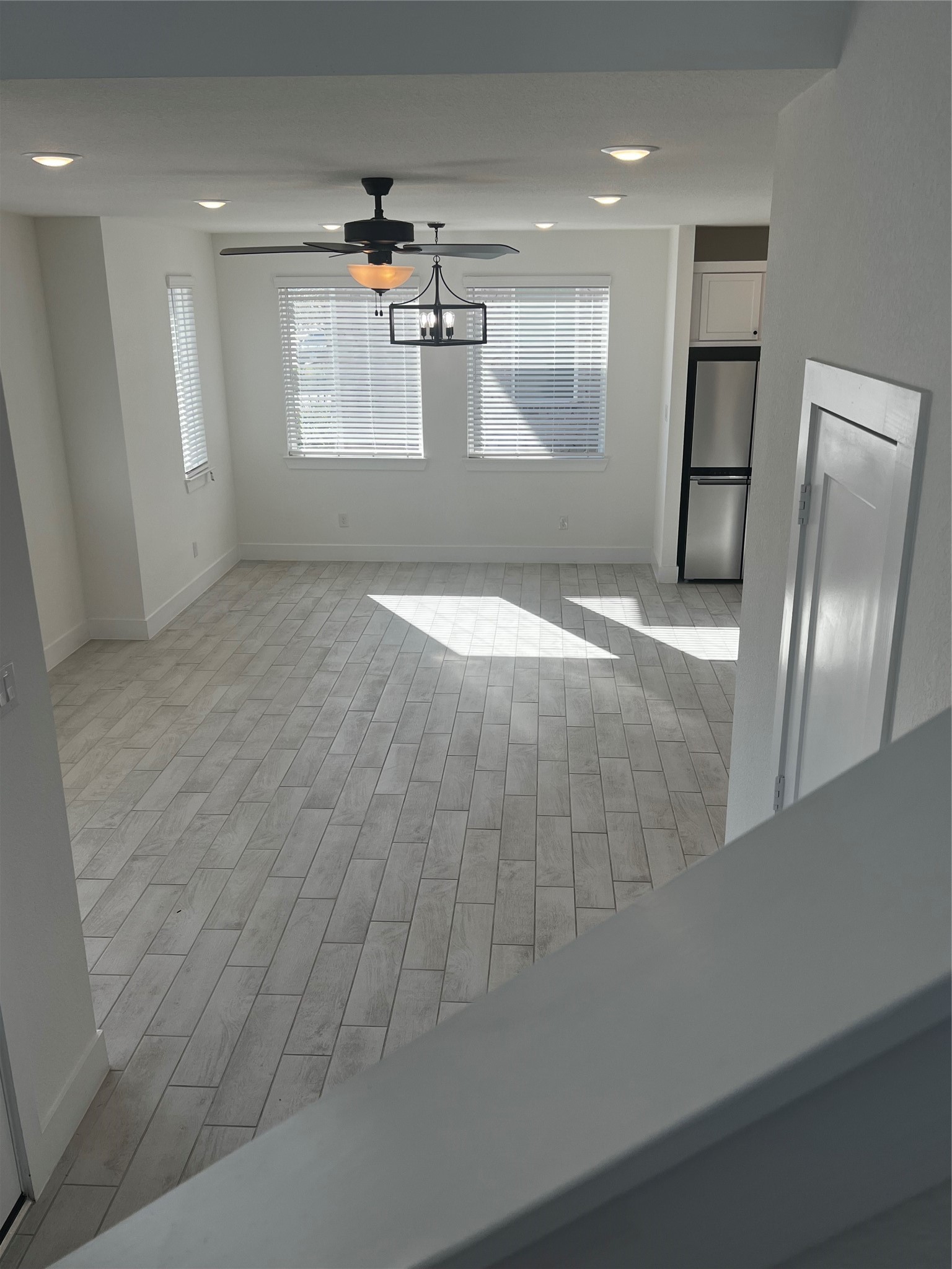 7743 Swooping Swallow Lane Katy, TX 77493 - Photo 27 of 45 an empty room with wooden floor and windows