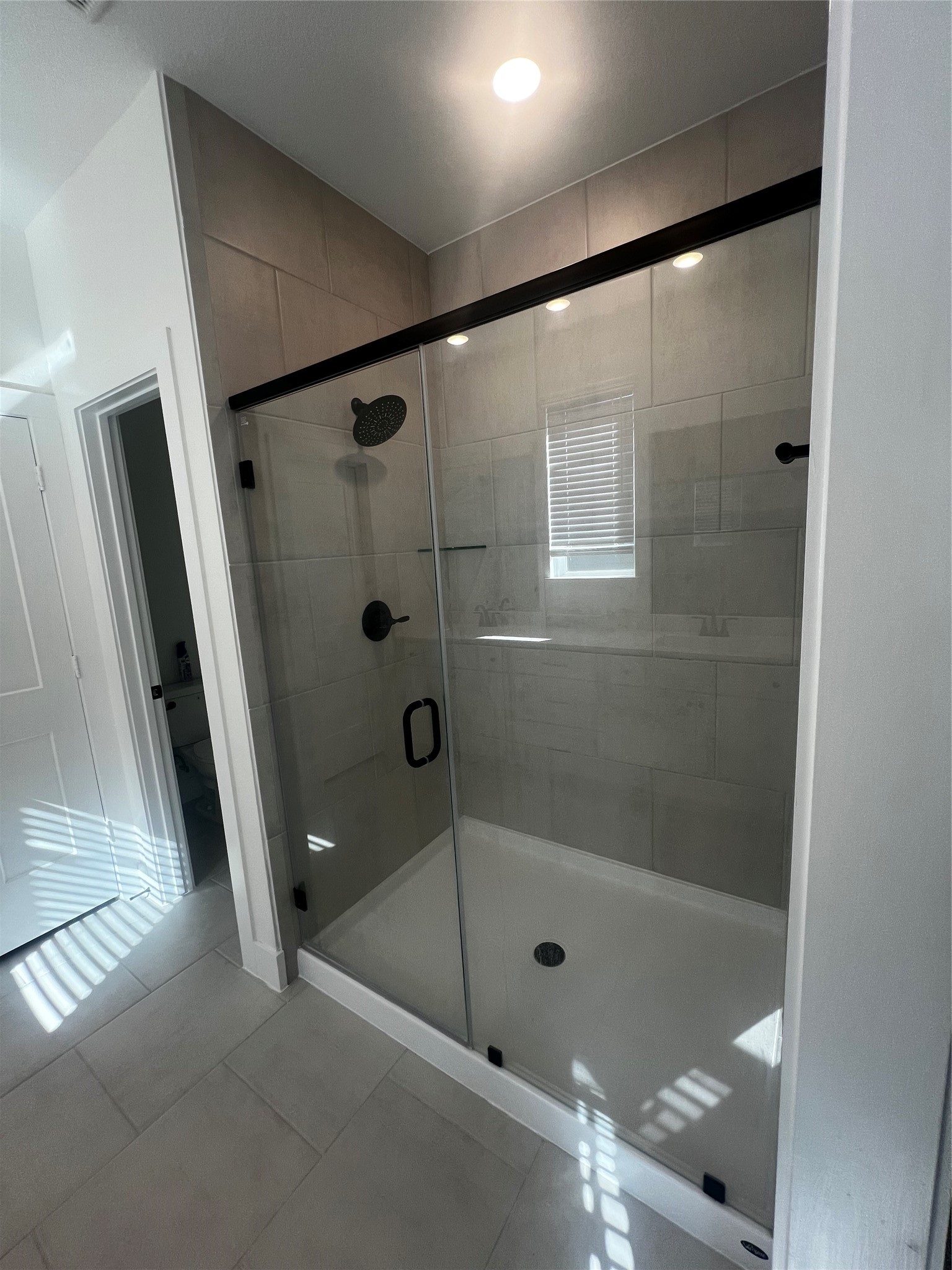 7743 Swooping Swallow Lane Katy, TX 77493 - Photo 34 of 45 a bathroom with a shower and a glass door