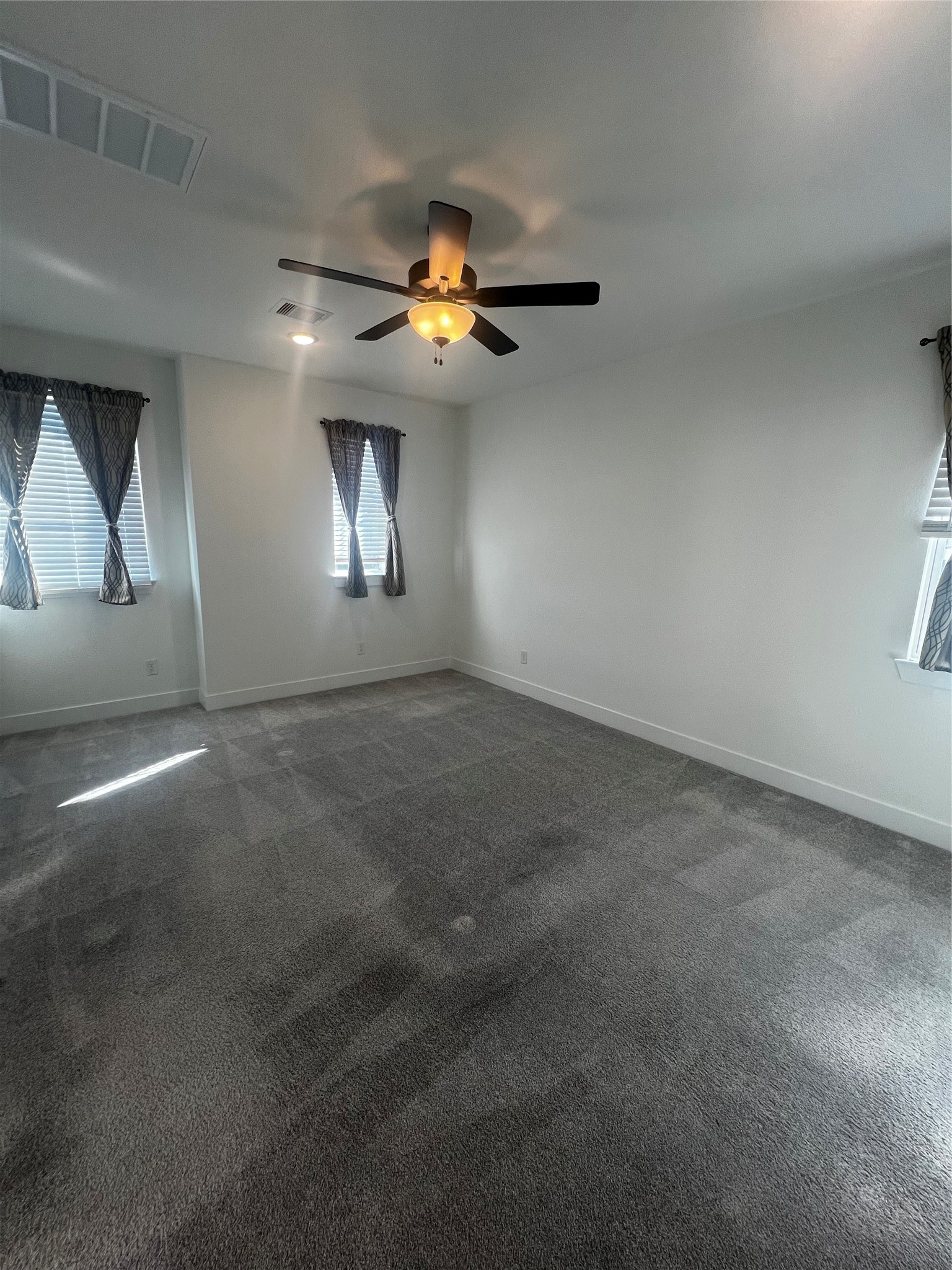 7743 Swooping Swallow Lane Katy, TX 77493 - Photo 37 of 45 an empty room with a window and ceiling fan