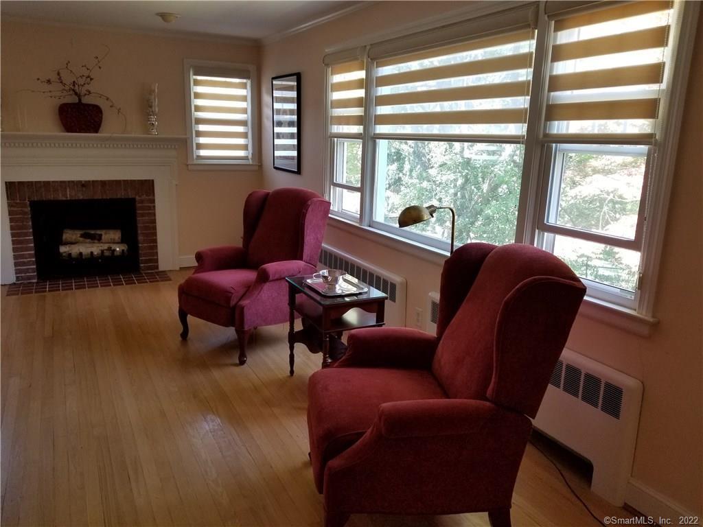 120 Jameswell Road Wethersfield, CT 06109 - Photo 1 of 1 a living room with furniture and a fireplace