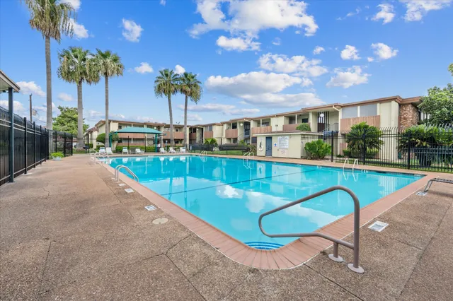 a view of a swimming pool with a lounge chairs