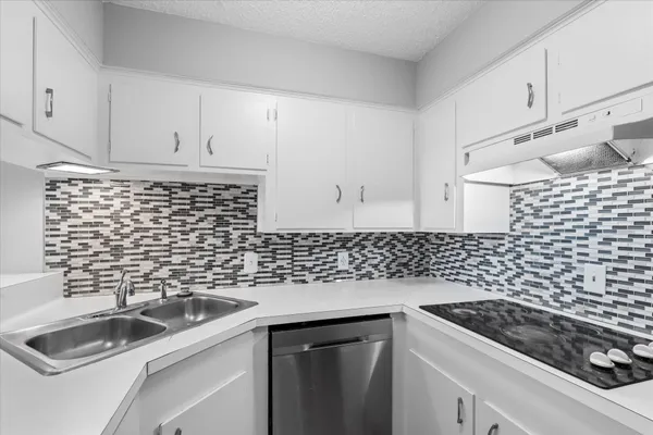 a kitchen with sink and cabinets