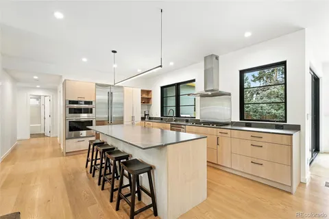 a large kitchen with kitchen island a large counter space and stainless steel appliances