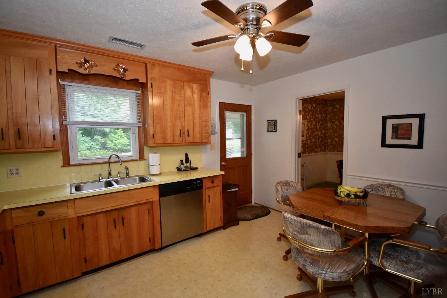 104 River Ridge Road Madison Heights, VA 24572 - Photo 10 of 35 a kitchen with a table chairs sink and cabinets