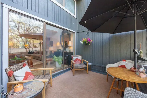 a outdoor space with a table and chairs