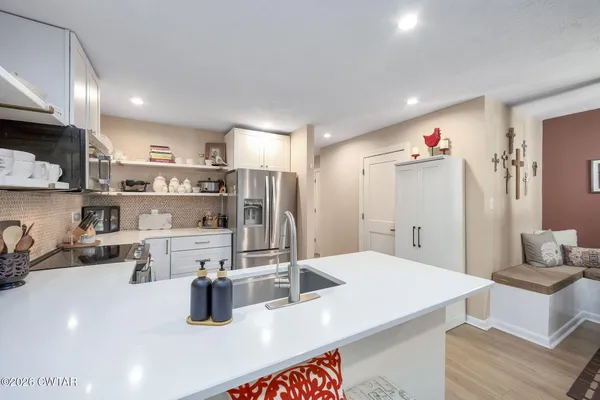 a kitchen with stainless steel appliances kitchen island granite countertop a sink and cabinets