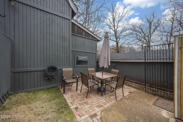 a view of a patio with a table and chairs