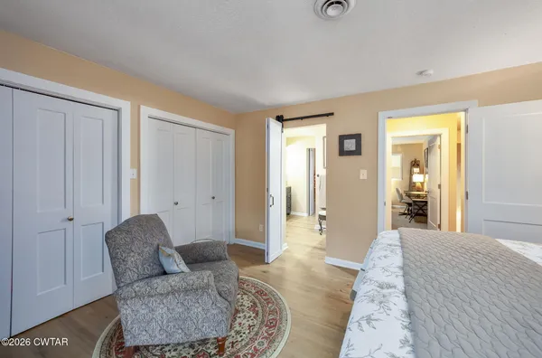 a spacious bedroom with a bed and couch