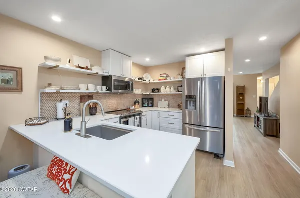 a kitchen with refrigerator and cabinets