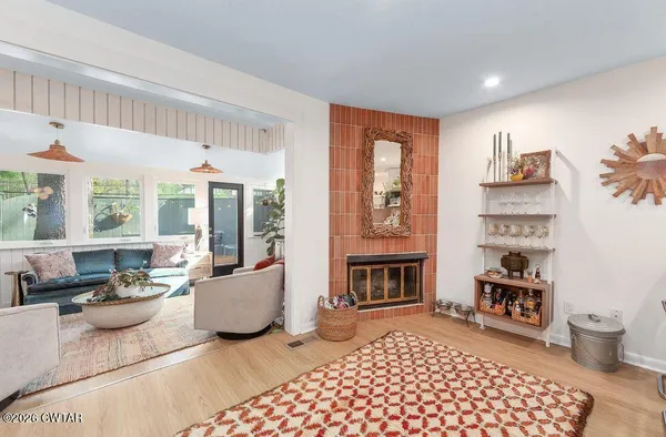 a living room with furniture and a fireplace