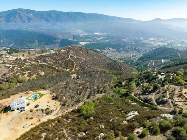 an aerial view of a house with a mountain view