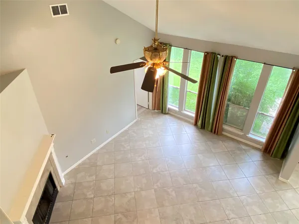 a view of a hallway to window with furniture