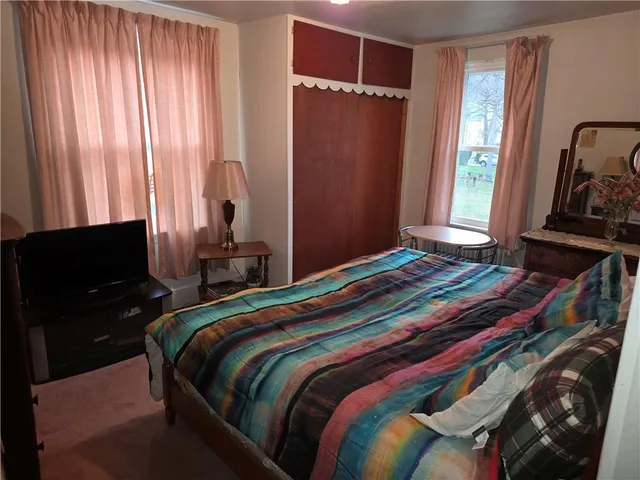 a bedroom with a bed and cabinets