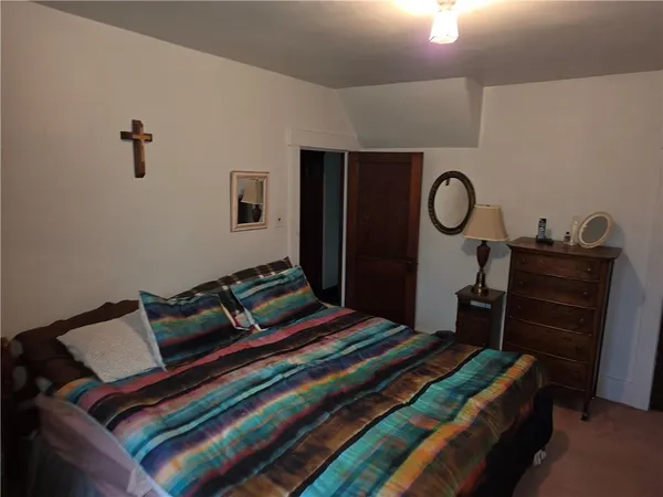 a bedroom with a bed and a table in it