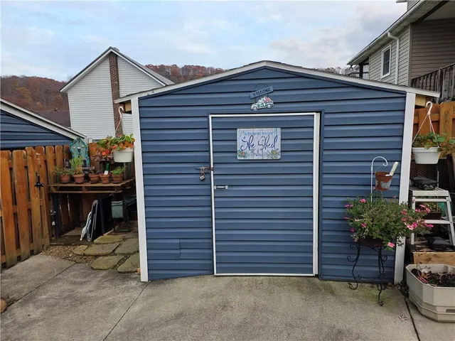 a view of a big house with a big yard and large trees