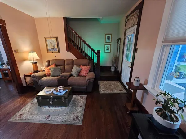 a living room with furniture and a mirror