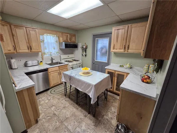 a kitchen with a refrigerator a stove a microwave and wooden cabinets