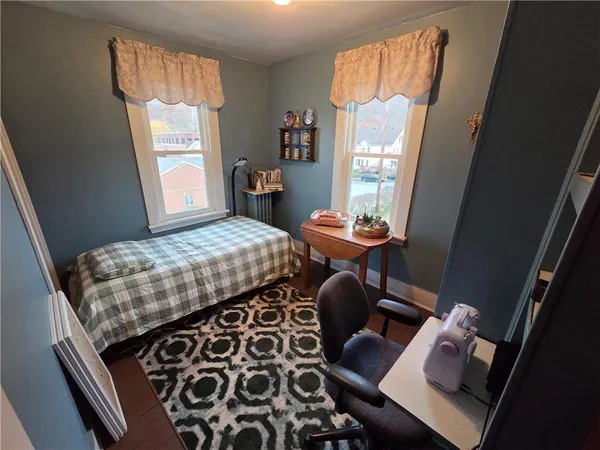 a bedroom with a bed and a flat tv screen