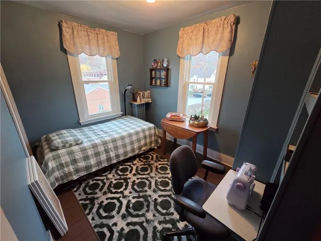 a bedroom with a bed and a flat tv screen
