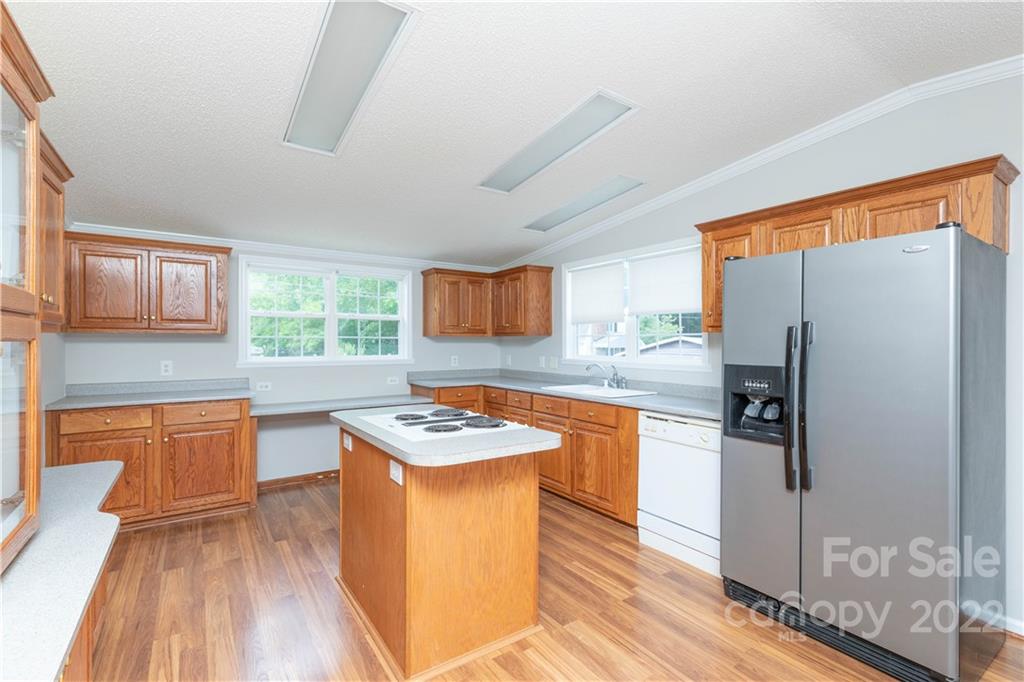 712 Hall Spencer Road Catawba, SC 29704 - Photo 11 of 32 a kitchen with stainless steel appliances granite countertop a refrigerator a sink dishwasher a stove with wooden cabinets and wooden floor