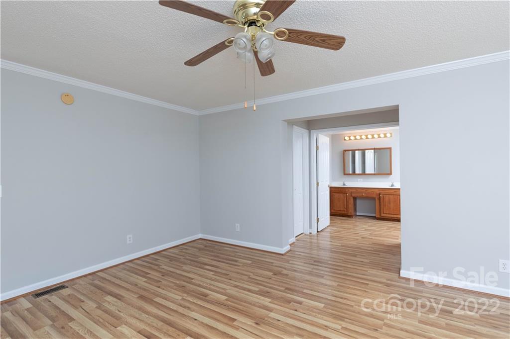 712 Hall Spencer Road Catawba, SC 29704 - Photo 16 of 32 a view of a room with wooden floor a ceiling fan and windows
