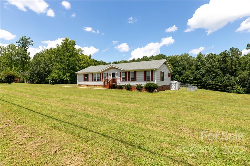 712 Hall Spencer Road Catawba, SC 29704 - Photo 3 of 32 a view of a house with pool and trees in the background