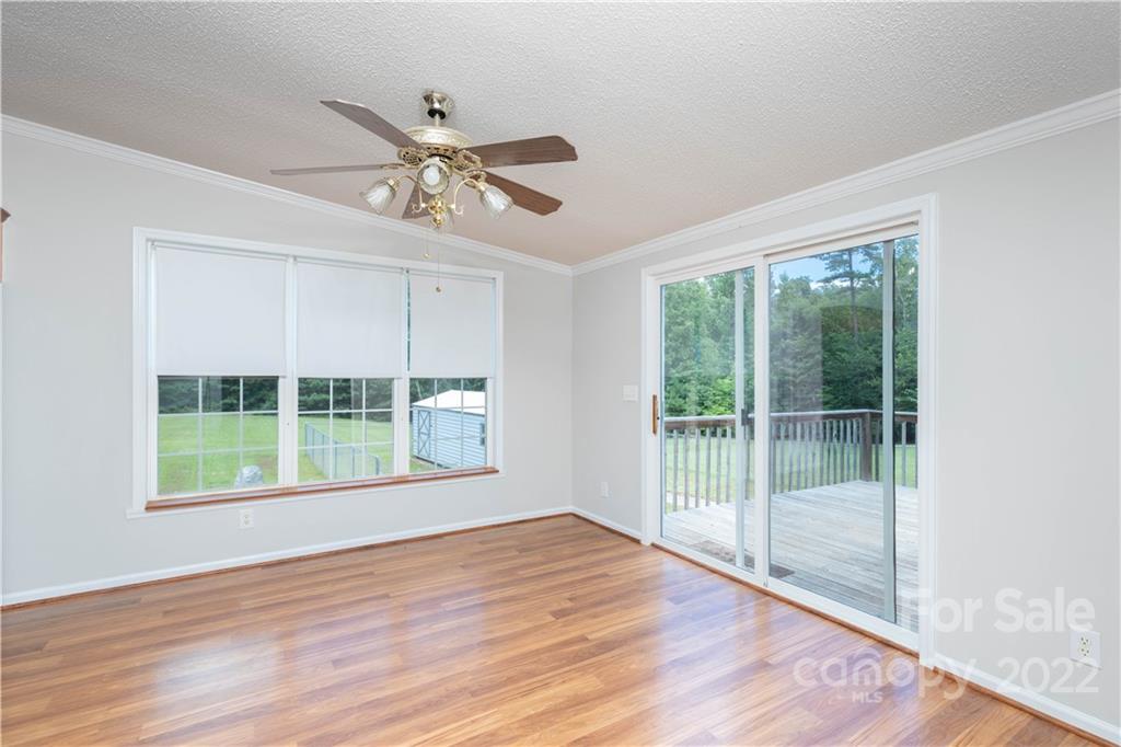 712 Hall Spencer Road Catawba, SC 29704 - Photo 9 of 32 a view of an empty room with wooden floor and a window