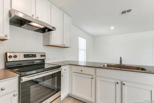 a kitchen with a sink and cabinets