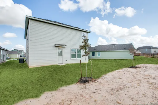a view of a backyard of the house