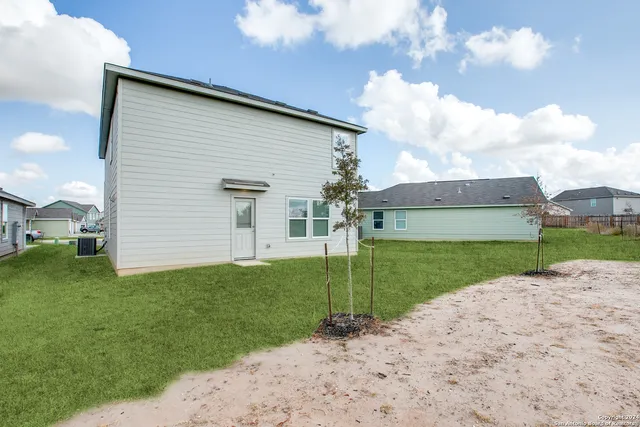 a view of a backyard of the house