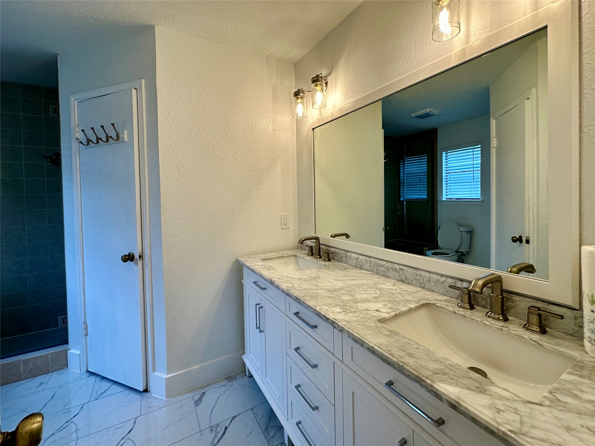 709 Brookside Pass Cedar Park, TX 78613 - Photo 8 of 10 Bathroom featuring a double vanity with a marble countertop, two vessel sinks, and a large mirror
