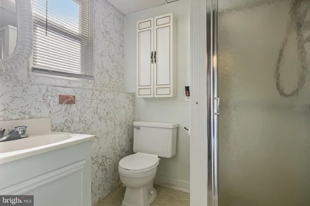 a bathroom with a toilet sink and shower