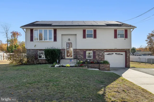 a view of a house with a yard and sitting area