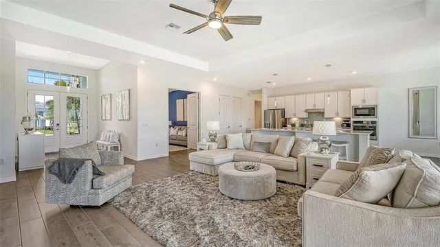 a bedroom with a large bed and a chandelier