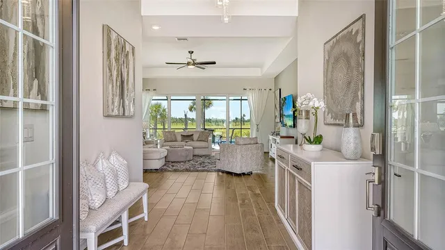 a living room with patio furniture and wooden floor