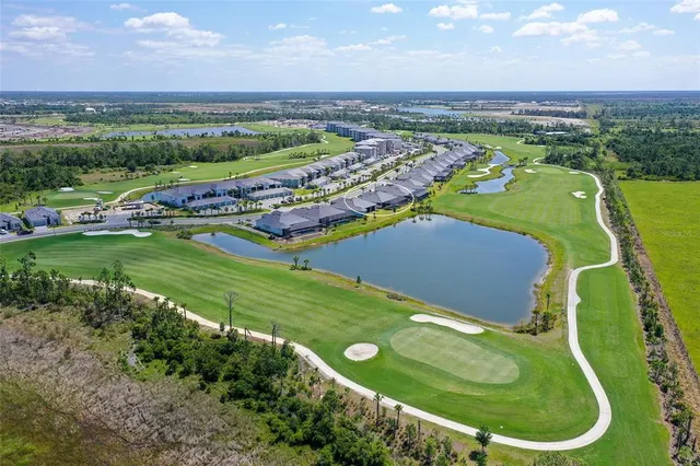 an aerial view of a house with a swimming pool patio and outdoor seating