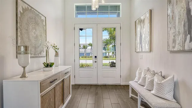 a view of a dining room with furniture large windows and wooden floor