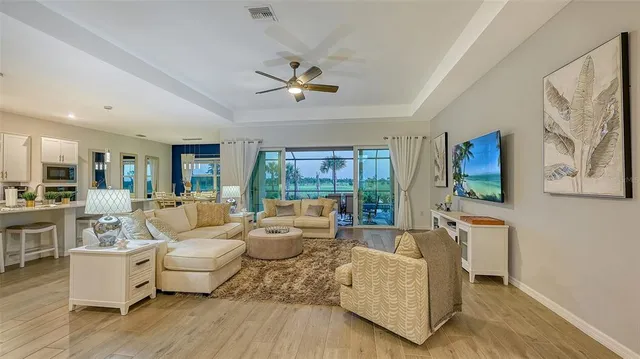 a kitchen with kitchen island granite countertop a counter space dining table and stainless steel appliances