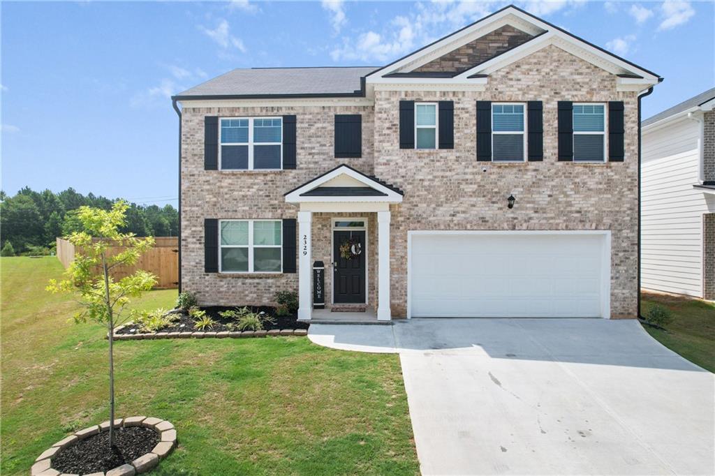 a front view of a house with a yard