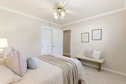 a bedroom with a bed and a chandelier