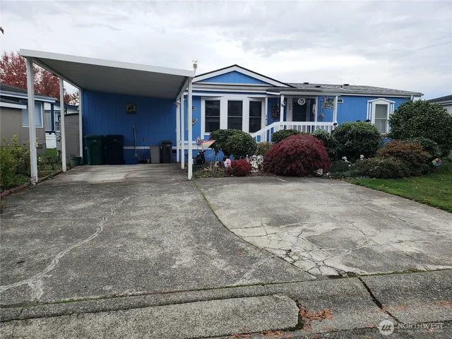a view of a house with a patio and a yard
