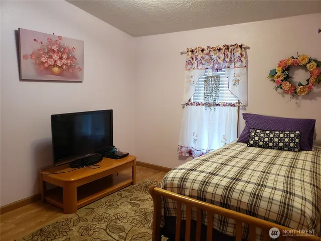 a bedroom with a bed and a mirror