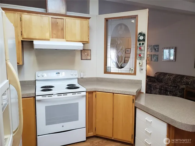 a kitchen with a stove and a microwave