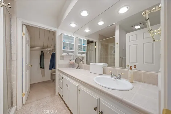 a bathroom with a double vanity sink and mirror