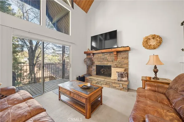 a living room with furniture fireplace and flat screen tv