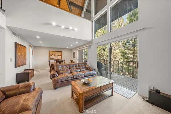 a living room with furniture and a floor to ceiling window