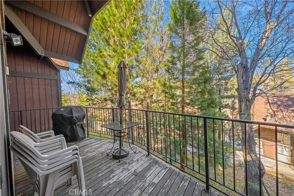 a view of balcony with wooden floor and outdoor seating