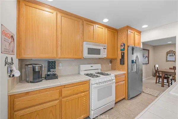 a kitchen with stainless steel appliances granite countertop a refrigerator stove and sink